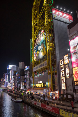 Osaka, Japan- 27 Nov, 2019: Beautiful landscape view of Japanese store with crowd of peoples and tourists at Dotonburi walking street on night time. Dotonburi is one of popular landmark of Osaka.のeditorial素材