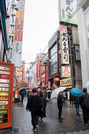Osaka, Japan- 28 Nov, 2019: People visit Dotonbori street in Osaka during raining day. Dotonbori is the main entertainment area of Osaka.のeditorial素材