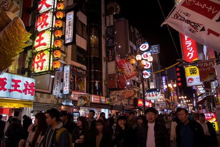 Osaka, Japan- 01 Dec, 2019: Tourists walking around pedestrian walking street at Dotonbori arcade under night light signs in Namba district of Osaka, Japanのeditorial素材