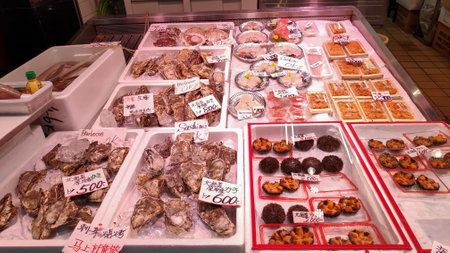 Osaka, Japan- 28 Nov, 2019: Seafood display with a variety of seafood and affordable price front of retail store in Osaka fresh market.のeditorial素材