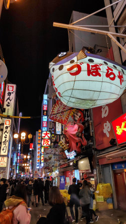 Osaka, Japan- 01 Dec, 2019: Tourists walking around pedestrian walking street at Dotonbori arcade...