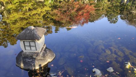 Traditional stone lantern (toro) on the pond of Kokoen Garden near Himeji castle Japan