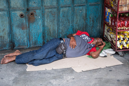 Johor Bahru, Malaysia- 27 Jan, 2020: Indian beggar sleeps on the street in Johor Bahru.のeditorial素材