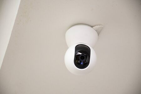 CCTV security camera on wall in the home for surveillance monitoring home guard system.