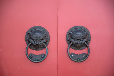 Lion head door knob with red Chinese style wooden doorの写真素材