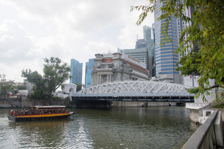 Singapore Dec 26 2021: Scenic view of traditional tourist boats sailing along the Singapore Rive in downtown of Singaporeのeditorial素材