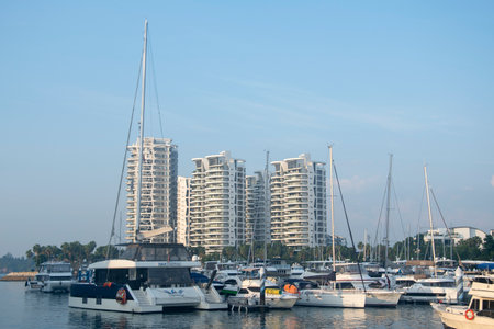 Singapore- Apr 2, 2022: Modern yachts park around Sentosa Cove along with luxury mansions. Sentosa Cove is a residential enclave in the eastern part of Sentosa island in Singaporeのeditorial素材