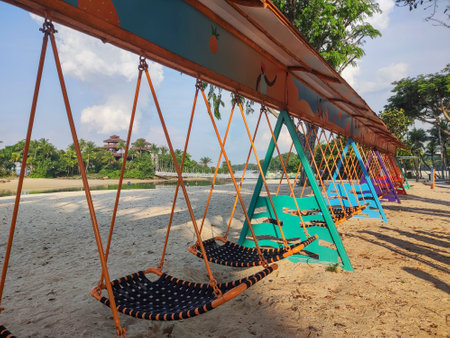 Singapore- Apr 2, 2022: Sentosa Hammock Swing in Sentosa, Singapore. Located at Palawan Beach near the iconic bridge, the ultra-long Hammock Swing can fit up to 18 people.のeditorial素材