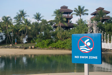 Singapore- Apr 2, 2022: No swimming sign placed at the Sentosa beach in Singapore.のeditorial素材