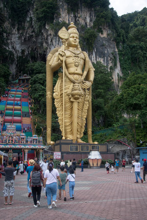 Kuala Lumpur, Malaysia - Jun 06, 2022: Giant golden statue Lord of Murugan before entering the...