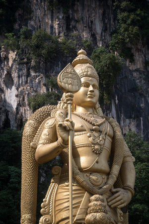 Kuala Lumpur, Malaysia - Jun 06, 2022: Giant golden statue Lord of Murugan before entering the...