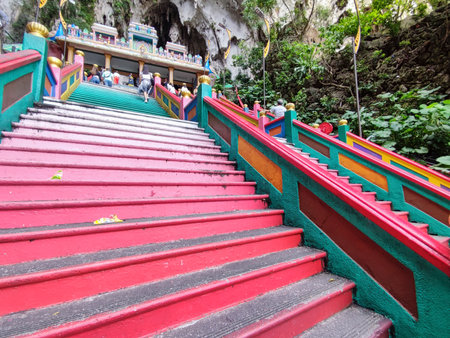 Kuala Lumpur, Malaysia - Jun 06, 2022: People visiting the Batu Caves by climbing the colorful staircase in Kuala Lumpur.のeditorial素材