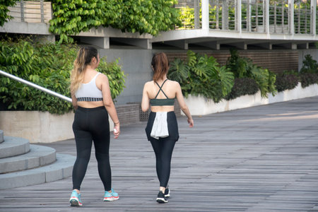 Singapore- May 15, 2022: Two ladies jog along Marina Bay in Singapore.のeditorial素材