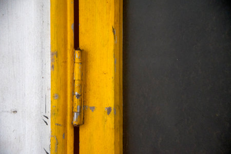 Yellow door hinges at wooden ancient houseの写真素材