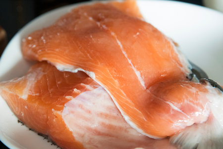 Raw salmon fillets placed on the plate.の写真素材