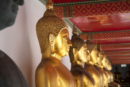 Golden Buddha statues in Wat Pho, Bangkok. Wat Pho is one of the oldest and largest temples in Bangkok features the famous Reclining Buddhaの写真素材