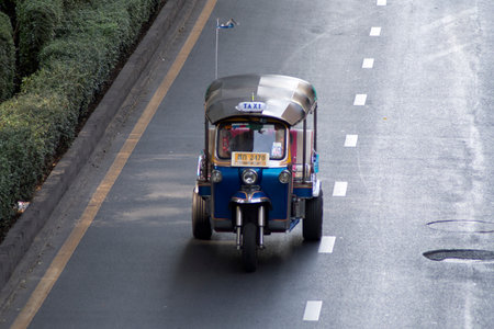 Bangkok, Thailand- 13 Feb, 2023: Traditional tuk-tuk on the road in Bangkok. Tuk tuks are motorized 3-wheeled rickshaws that ferry passengers aroundのeditorial素材