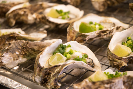 Grilled oysters sold on the street market of Bangkokの写真素材