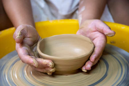 Females ceramics maker working with pottery wheelの写真素材