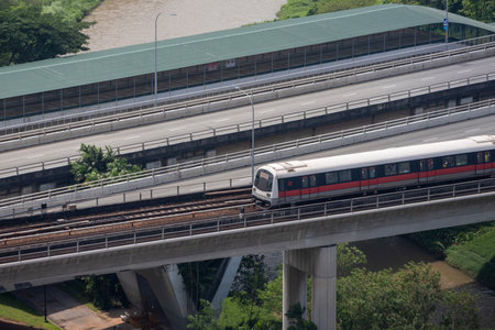 Singapore- Feb 11, 2024: MRT train is travel along the track in Singapore. MRT train is the most important public transport is Singapore.のeditorial素材
