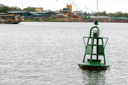 Green buoy on the river for the safety and security of the boats travelling on the waterの写真素材