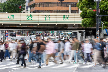 Tokyo, Japan- 12 May 2024: People cross the busy intersection in Shibuya, Tokyo. It is one of the busiest intersections in the world. (purposely blurred to show movement of people)のeditorial素材