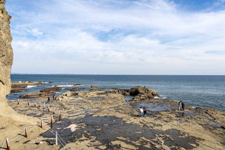Enoshima, Japan- 14 May, 2024: Rocks and sea at Chigogafuchi Abyss in Enoshima Island, Japan. Its is a beautiful location in which Mt. Fuji can be seen in the backgroundのeditorial素材