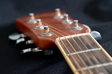 Close-Up Acoustic Guitar strings, with focusing on the detailed strings of the guitar