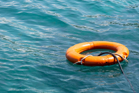 Orange lifebuoy floats on the ocean. Security concept.の写真素材
