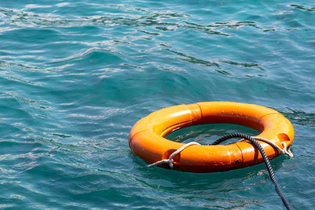 Orange lifebuoy floats on the ocean. Security concept.の写真素材