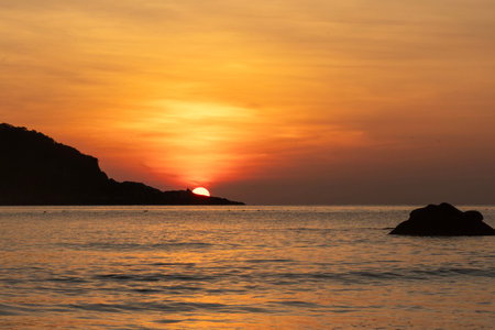 Breathtaking sunrise captured on Redang Island, Malaysia. Radiant sun light and colourful sky, enhancing the natural beautyの写真素材