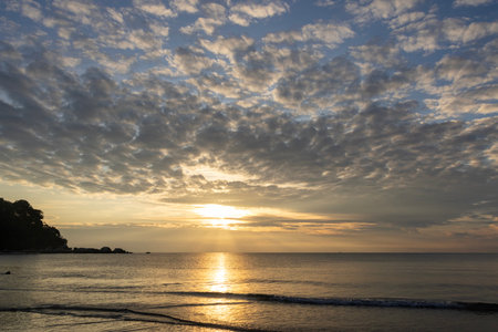 Morning in Teluk Cempedak beach in Kuantan, Malaysia. Loads of people taking morning strolls along the beachの写真素材