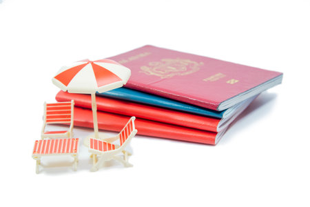 Miniature chairs and umbrella with passport for travelling concept. Concept of relaxation.の写真素材