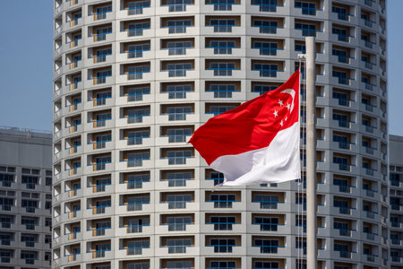 Singapore flag  with city high-rise building as backgroundの写真素材