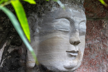 Buddha sculpture located at Dazu Rock Carvings on Mount Baoding, Dazu, China. Dazu Rock Carvings are Chinese religious sculptures and carvings, influenced by Buddhist, Confucian, and Taoist beliefsの写真素材