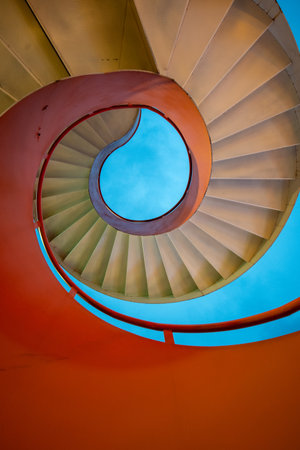 Bright orange spiral staircase. Orange spiral staircase made from metalの写真素材
