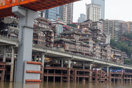 Chongqing, China- 8 Nov 2025: View Hongyadong Scenic Area from the Jialing river in Chongqing, China. Hongya Dong is an 11-story stilt-building complex in the main commercial districtのeditorial素材