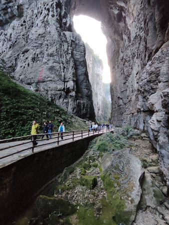 Chongqing, China-4 Nov 2025: Tourists visit to Three Natural Bridges at Wulong Karst Geological Park, Chongqing. It is natural limestone arches situated in a deep canyon, carved by flowing water.のeditorial素材