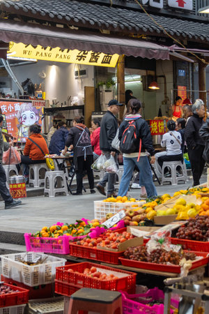 Chongqing, China- 2 Nov 2025: Local people visit to the wet market in Chongqing, China. Most wet markets simply sell perishable goods like meat, fruit and vegetablesのeditorial素材