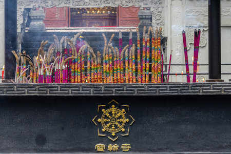 Chongqing, China- 10 Nov 2025: Burning joss sticks or incense sticks placed in the metal burners at Baolun Temple in Chongqing, China. Baolun Temple is  known for its thousand-year historyのeditorial素材