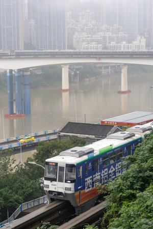 Chongqing, China- 7 Nov 2025: Chongqing metro train travel on the high rise track in Chongqing city,...