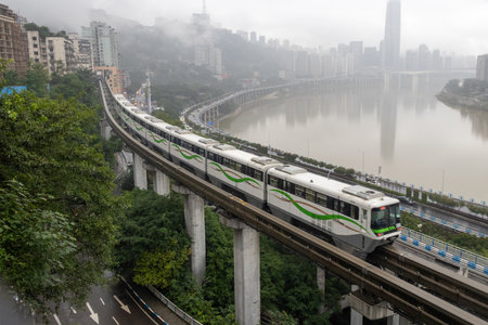 Chongqing, China- 7 Nov 2025: Chongqing metro train travel on the high rise track in Chongqing city, China. It serves the transportation needs of the city main business areas and inner suburbs.のeditorial素材