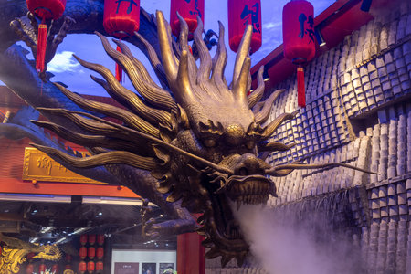 Chongqing, China- 3 Nov 2025: Bronze sculpture of Chinese dragon with beautiful lighting shine on it. Located at Shibati or Eighteen Stairs, in Chongqing, Chinaのeditorial素材