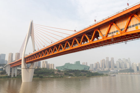 Chongqing, China- 2 Nov 2025: Overview of Qiansimen bridge where it cross the Jialing river in Chongqing, China. Qiansimen Bridge in Chongqing is a modern architectural marvelのeditorial素材