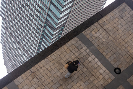 Chongqing, China- 11 Nov 2025: Skyscrapers with upside-down reflections in the mirror at Chongqing, China. A futuristic concept.のeditorial素材
