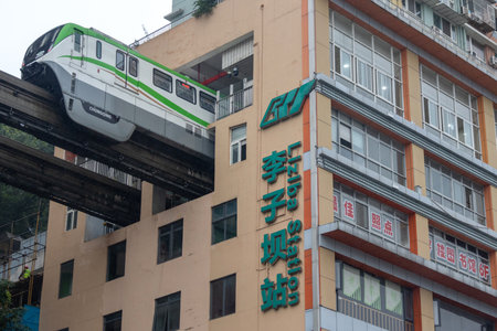 Chongqing, China- 7 Nov 2025: Chongqing metro train passes through a residential building at Liziba...