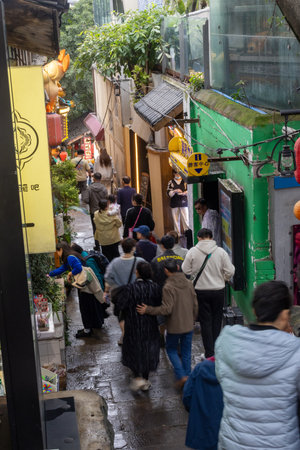 Chongqing, China- 11 Nov 2025: Tourists visit to Shancheng Alley or Mountain City Alley in Chongqing, China. It is a historic and scenic network of stepped lanes, exemplifies mountain city identityのeditorial素材