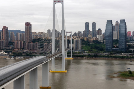 Chongqing, China- 10 Nov 2025: Nanjimen Yangtze River Bridge in Chongqing, China. It is a rapid transit cable-stayed bridge that crosses the Yangtze river and carries Rail Transit Line 10 trainsのeditorial素材