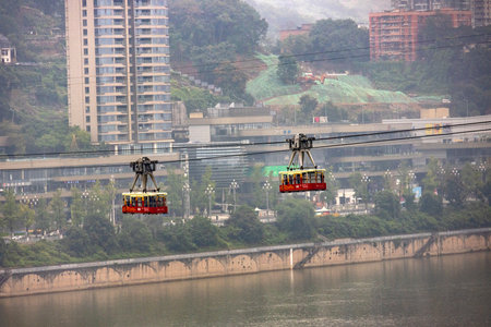 Chongqing, China- 3 Nov 2025: Cable car of Chongqing Yangtze River Cableway crossing the river in Chongqing, China. It has developed into a must-visit attraction for touristsのeditorial素材