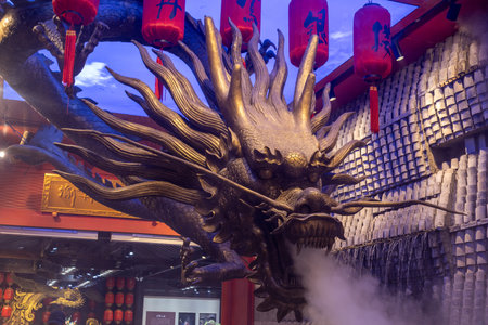 Chongqing, China- 3 Nov 2025: Bronze sculpture of Chinese dragon with beautiful lighting shine on it. Located at Shibati or Eighteen Stairs, in Chongqing, Chinaのeditorial素材